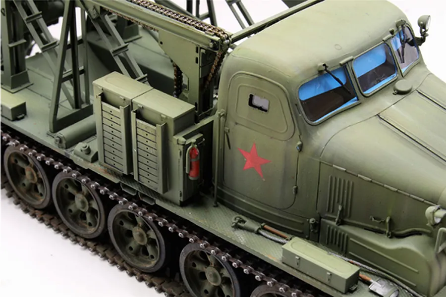 A high-angle view of a 1/35 scale Trumpeter BTM-3 trench digger model, painted in olive green with a red star decal on the door.