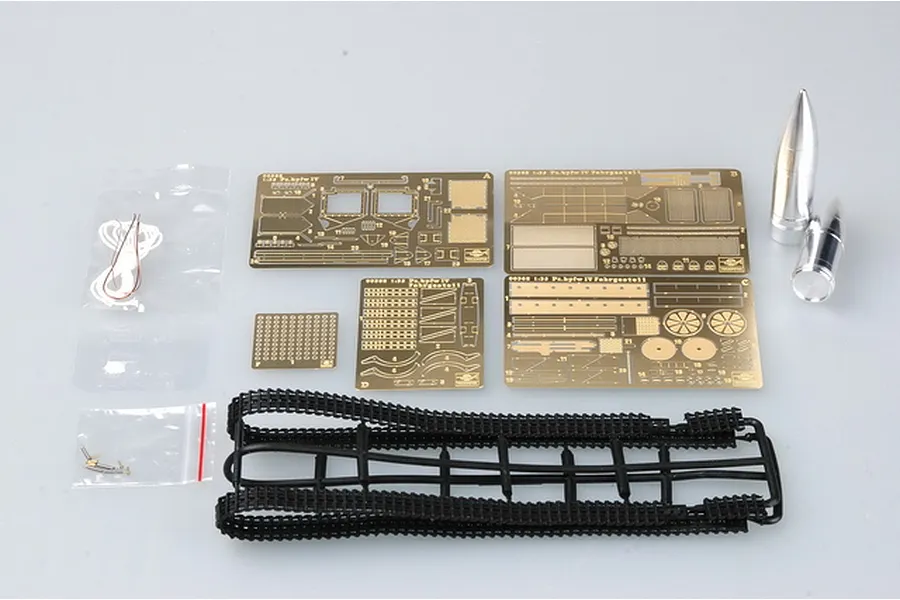 Trumpeter 1/35 scale German Pz.Kpfw IV model kit parts including photo-etched brass sheets, black plastic tank tracks, metal projectiles, and small hardware.