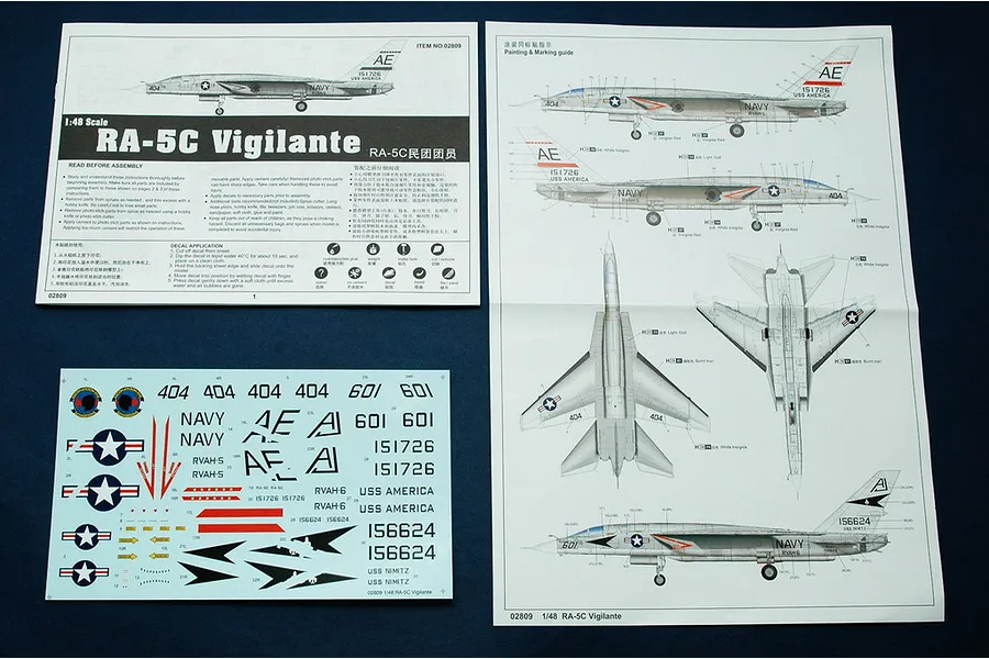 Instruction manual and decal sheet for the Trumpeter 1/48 scale RA-5C Vigilante plastic model kit laid out on a dark surface.