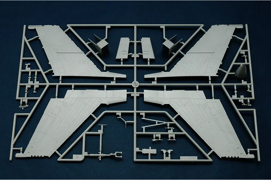 A grey plastic sprue containing model aircraft wing and tail components for a Trumpeter 1/48 scale model kit.