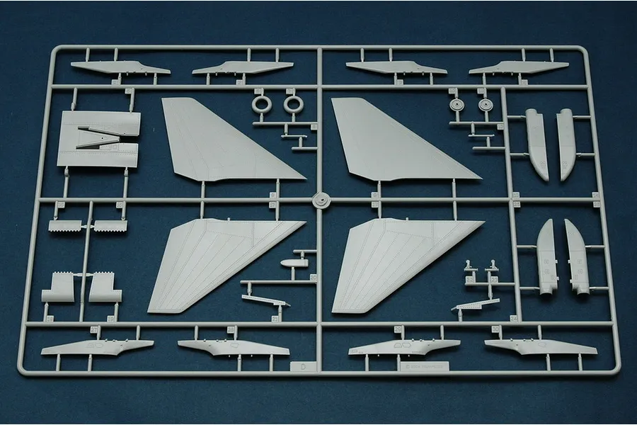 A grey plastic sprue from a Trumpeter 1/48 scale model kit containing various aircraft wing and fuselage parts.