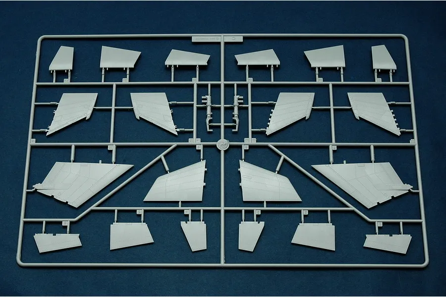A grey plastic model kit sprue containing various aircraft wing and control surface components for a 1/48 scale model.