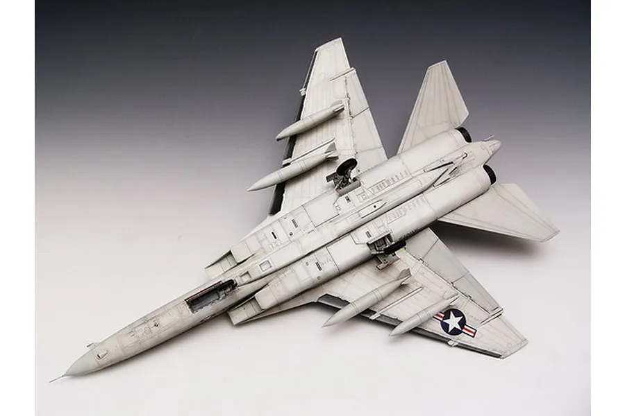 A high-angle view of a fully assembled and painted 1/48 scale Trumpeter RA-5C Vigilante model aircraft, showing the underside with landing gear and missiles.