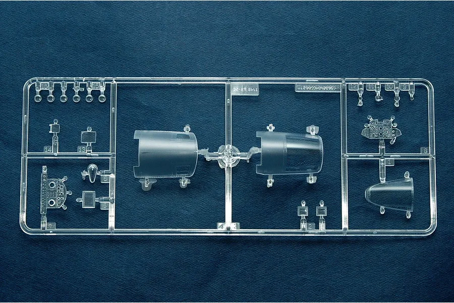 A clear plastic sprue containing canopy and cockpit parts for a 1/48 scale Trumpeter RA-5C Vigilante model kit, set against a dark blue background.