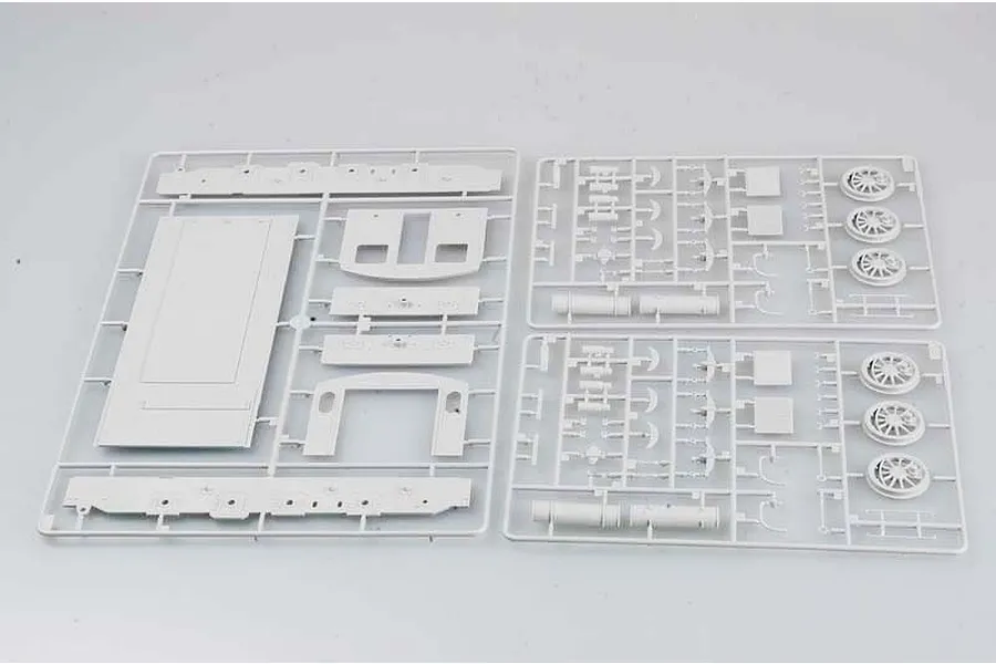 Three grey plastic model kit sprues containing parts for a German WR 360 C12 locomotive model, laid out on a plain white surface.