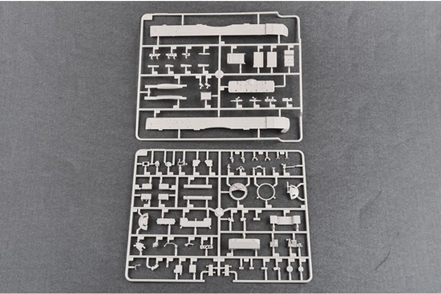 Two grey plastic model kit sprues containing various tank parts laid out on a dark grey surface.