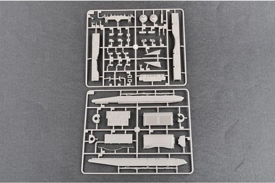 Two grey plastic model kit sprues containing various tank parts laid out on a dark grey surface.