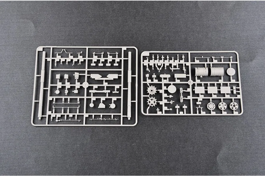 Two grey plastic model kit sprues containing various tank parts on a dark grey background.