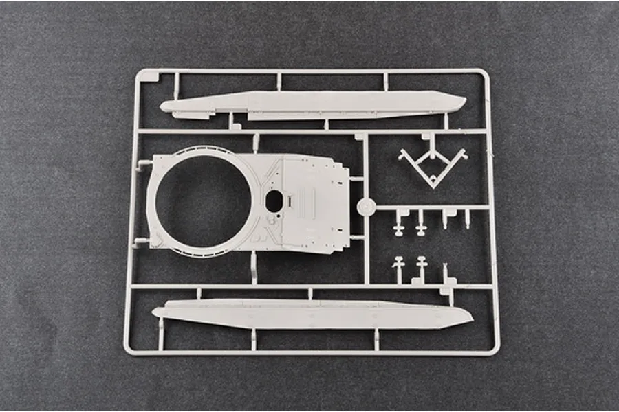 A plastic model kit sprue containing parts for a 1/35 scale tank, including the turret top and side hull panels, set against a dark grey background.
