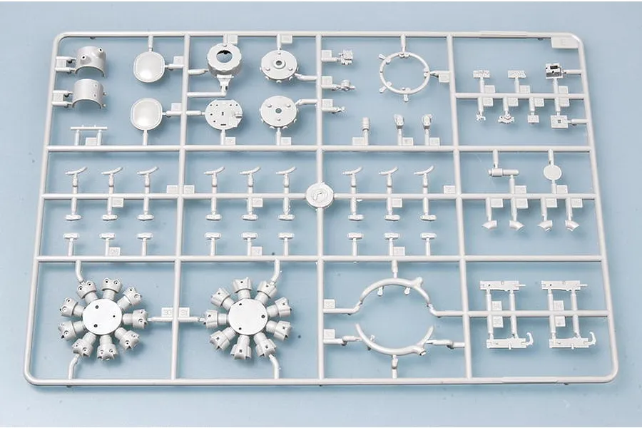 A grey plastic sprue containing various model aircraft parts, including radial engine components, for a Trumpeter 1/32 scale model kit.