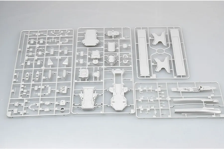 Four grey plastic model kit sprues containing various ship parts for a 1/350 scale model kit.