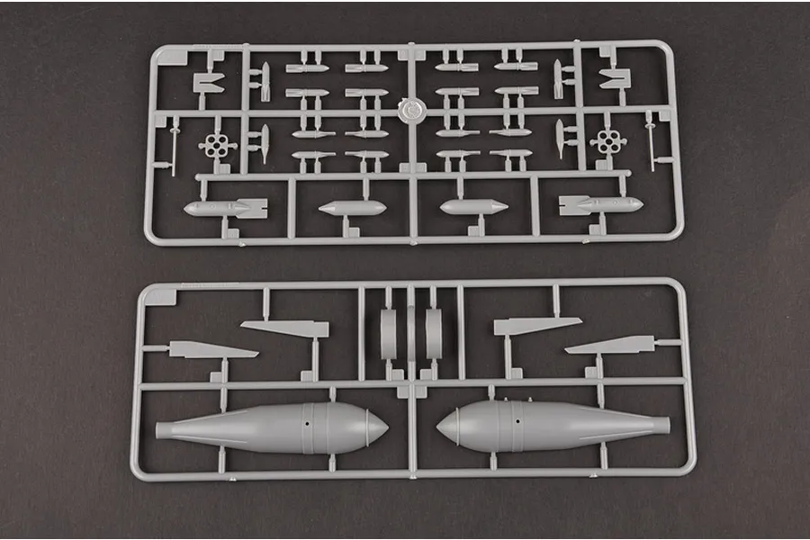 Two grey plastic model kit sprues containing various bomb and fuel tank parts for a 1/32 scale aircraft model.