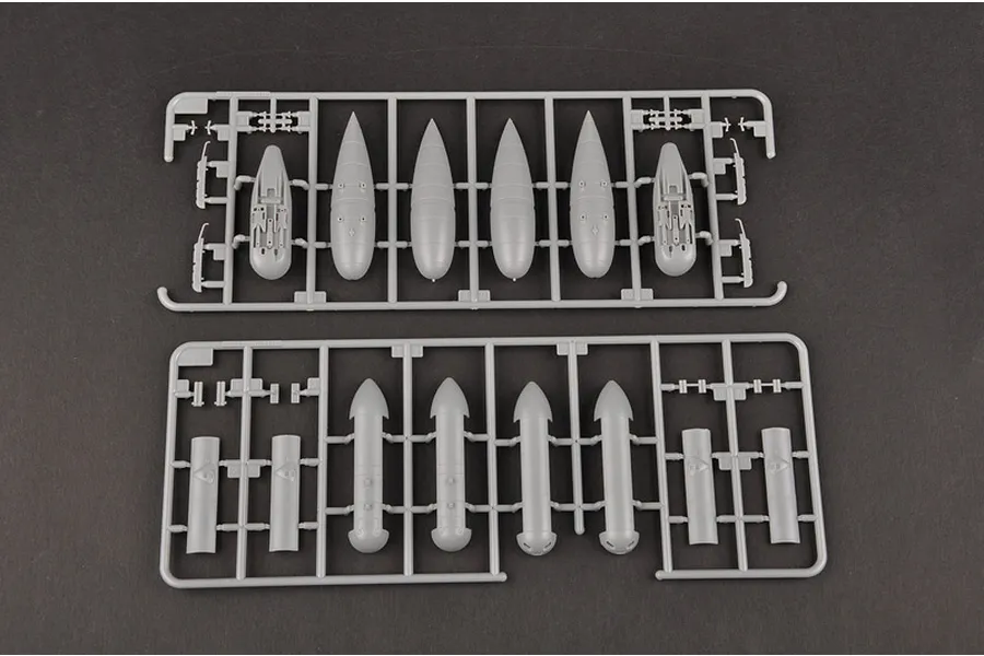 Two grey plastic model kit sprues containing various bomb and fuel tank components for a 1/32 scale aircraft model.