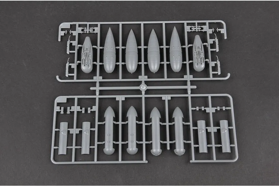 Grey plastic model kit sprue containing various bomb and ordnance parts for a 1/32 scale aircraft model.
