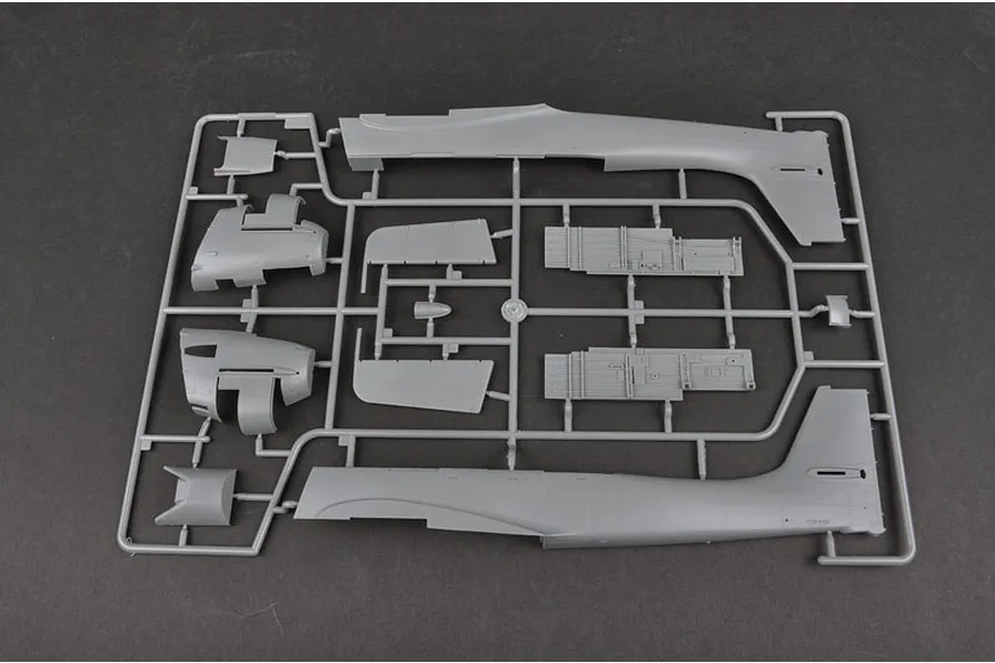A grey plastic sprue containing various model aircraft parts for a Junkers Ju-87B-2 Stuka, including fuselage halves and interior panels.