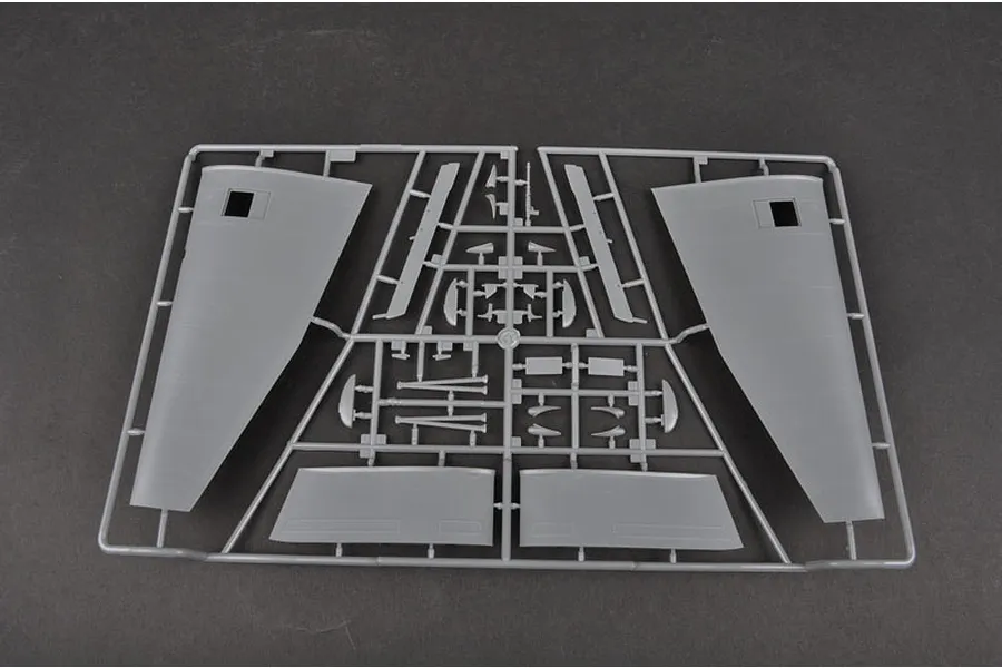 A grey plastic model kit sprue containing aircraft wing and control surface components for a Trumpeter model kit.