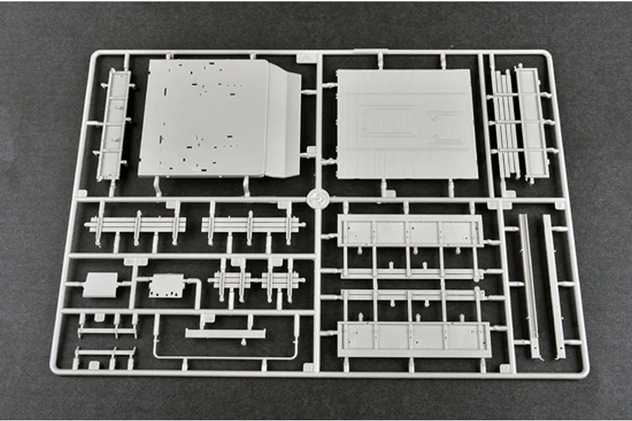 A grey plastic sprue from a 1/35 scale model kit containing various flat panels and structural parts for a military vehicle.