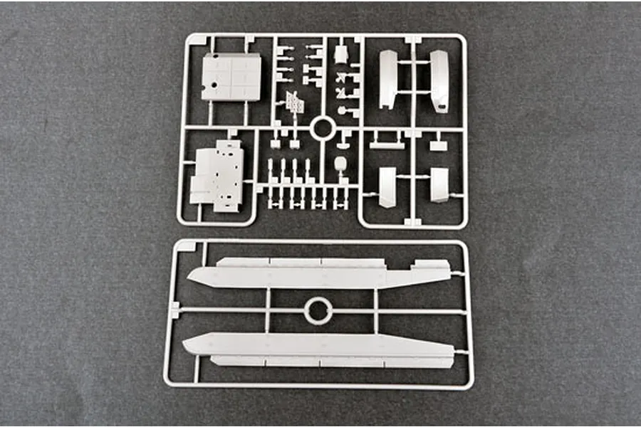 Two grey plastic model kit sprues containing various tank parts on a dark grey background.