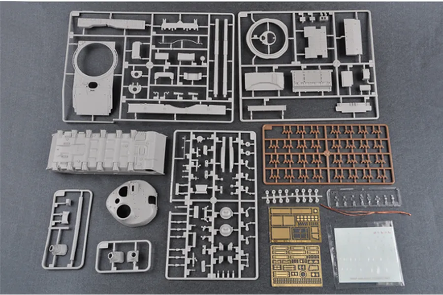 Plastic model kit sprues for a 1/35 scale tank, including grey plastic parts, a brown sprue, photo-etched metal sheets, and decal sheet.