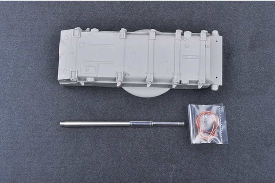 Plastic model tank hull, metal gun barrel, and a small bag of copper wire for the Trumpeter 1/35 T-62 tank kit.
