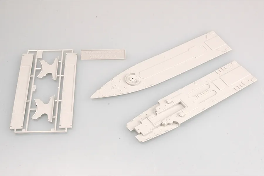 Unassembled plastic model kit parts for a 1/350 scale Russian Navy Moskva cruiser, including deck sections and a display nameplate.