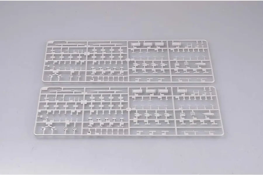 Two identical grey plastic model kit sprues containing various small ship parts on a plain background.