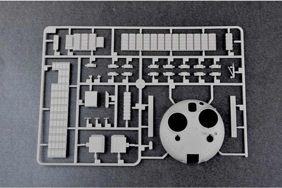 A grey plastic sprue from a Trumpeter 1/35 scale model kit featuring a tank turret and various small parts.