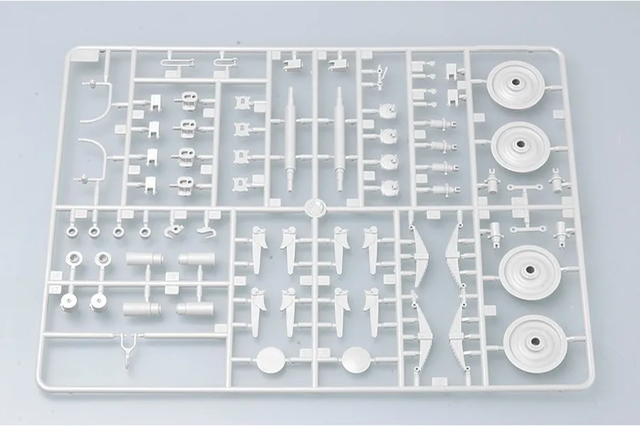 A grey plastic sprue from a Trumpeter 1/35 scale model kit containing various small mechanical parts, wheels, and suspension components.