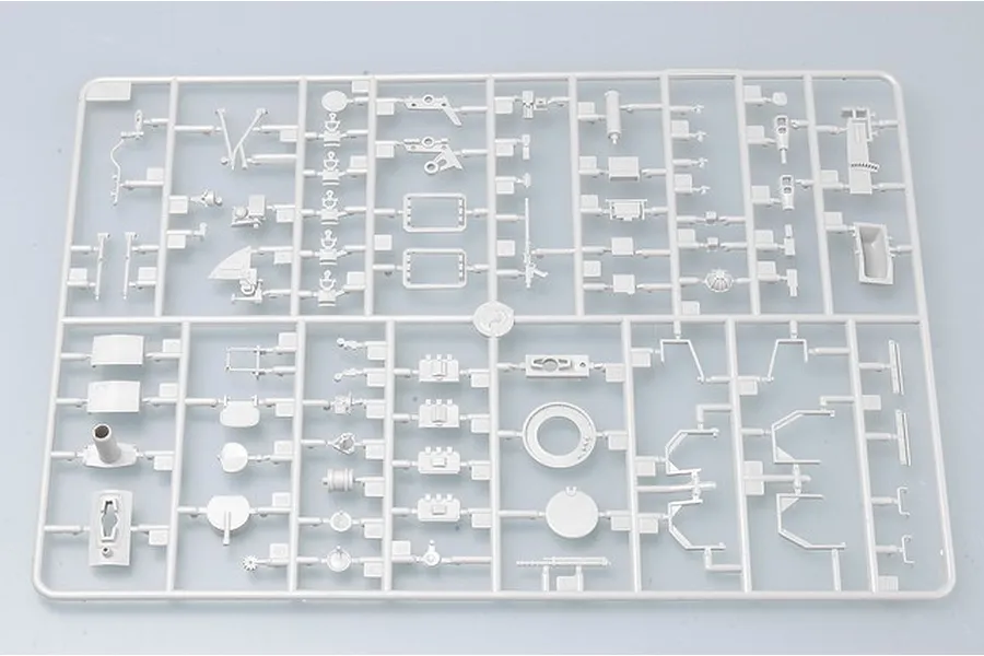 A light grey plastic model kit sprue containing various small parts for a 1/35 scale military vehicle model.