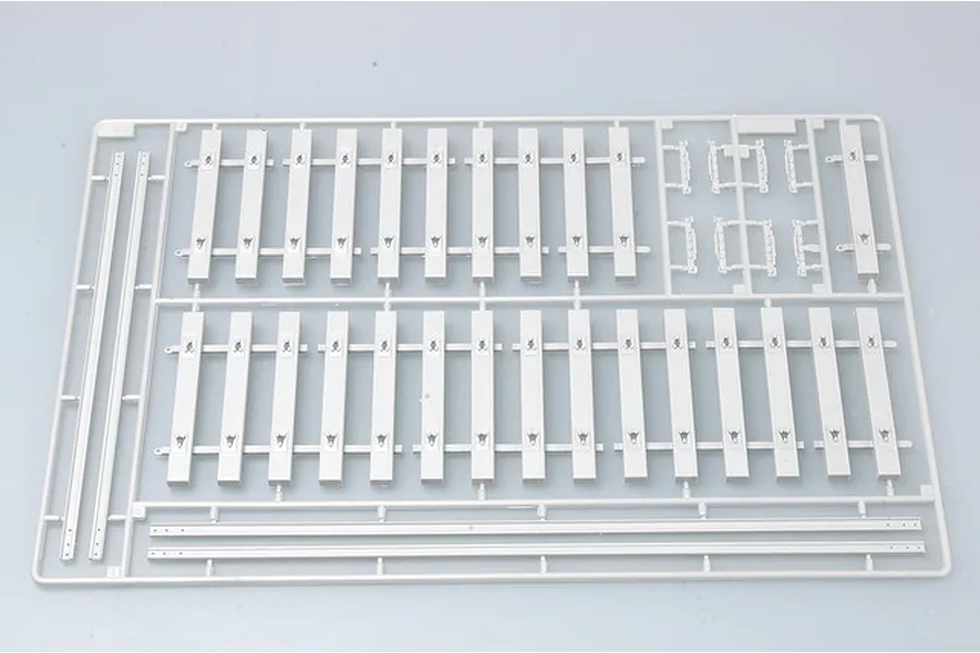 A grey plastic model kit sprue containing railway track sections and sleepers for a 1/35 scale armoured train model.
