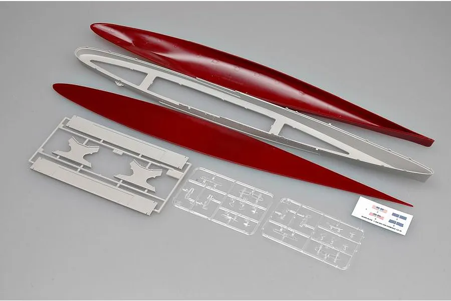 Plastic model kit parts for a 1/350 scale ship, including a red hull, grey deck supports, clear plastic sprues, and a small decal sheet.