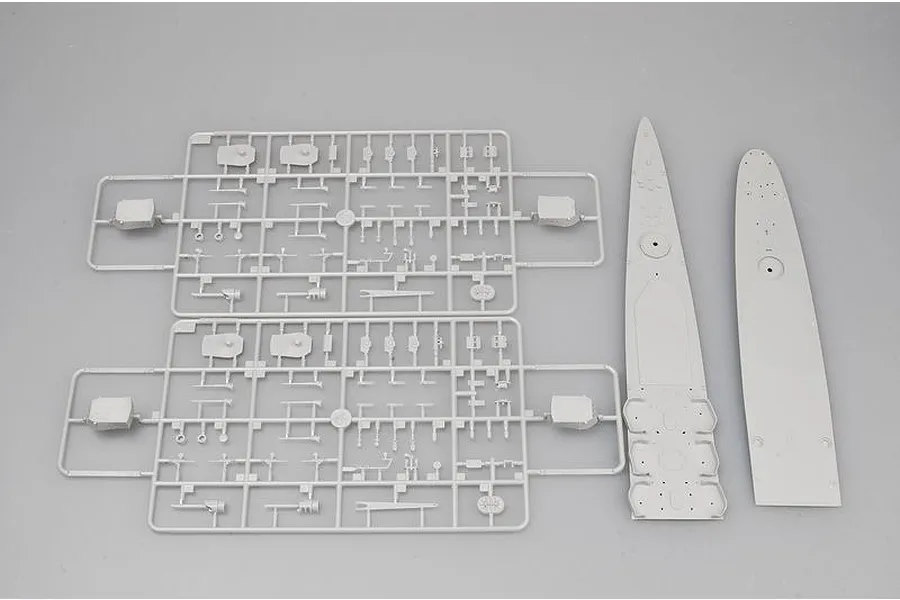 Two identical grey plastic model sprues and two ship deck sections laid out on a plain grey background.