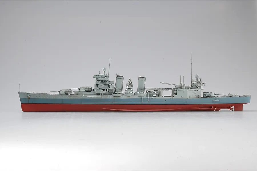 A side-profile view of a 1/350 scale plastic model of the USS San Francisco CA-38 heavy cruiser, featuring a grey upper hull and red lower hull.