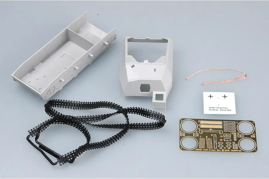 Unassembled plastic model kit parts for a 1/35 scale German Dicker Max tank, including hull, turret, tracks, photo-etched parts, and decals.