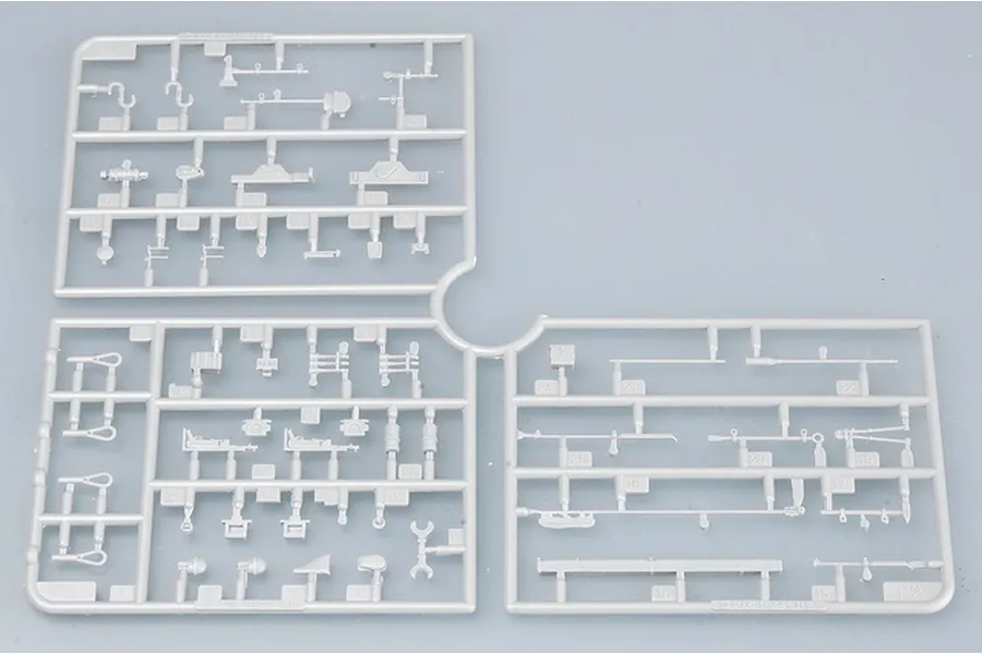 A light grey plastic sprue containing various small model parts for a 1/35 scale military vehicle kit.