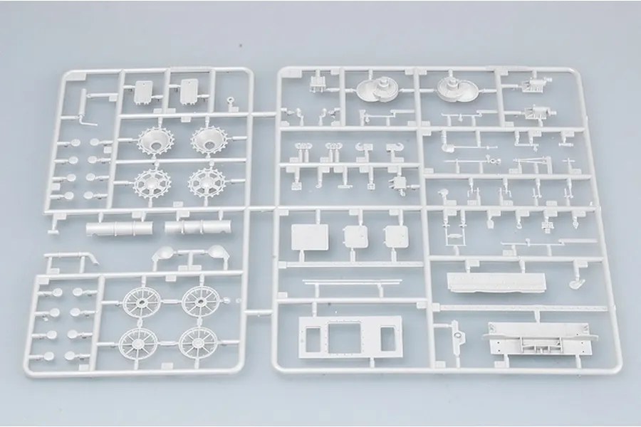 A grey plastic sprue containing various unpainted model tank parts, including wheels, hatches, and structural components for a 1/35 scale model kit.