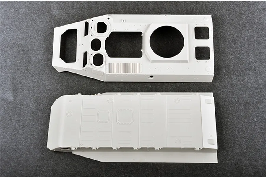 Top and bottom hull parts for a 1/35 scale Trumpeter Soviet MT-LB 6MB plastic model kit, shown on a grey surface.