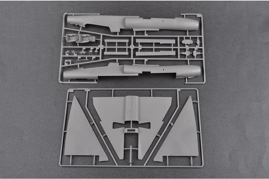 Two grey plastic model kit sprues containing fuselage halves and wing sections for a 1/48 scale aircraft model.