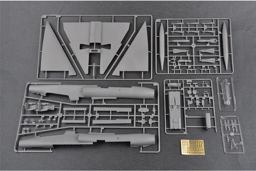 Plastic model kit sprues for a Trumpeter 1/48 F-106B Delta Dart, including grey plastic parts, clear canopy pieces, and a small photo-etched metal sheet.