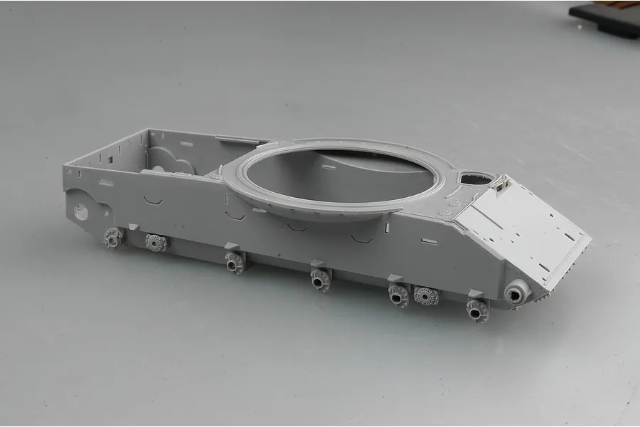 A grey plastic model tank hull component from a Trumpeter 1/35 scale kit, showing the main chassis and turret ring.