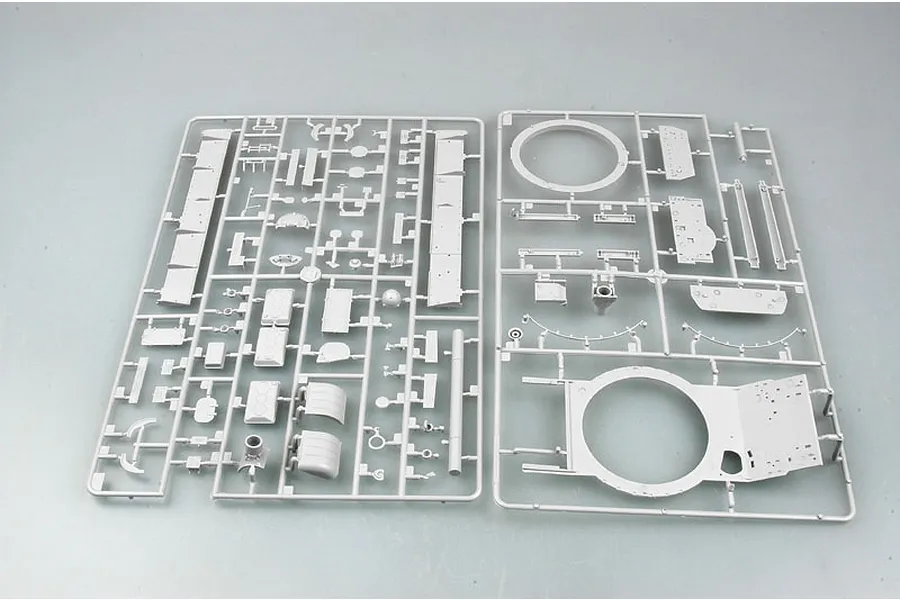 Two grey plastic model kit sprues containing various tank parts laid out on a plain surface.