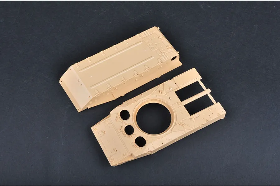 Tan plastic model kit parts for a BMP-3 tank hull and upper deck on a dark background.
