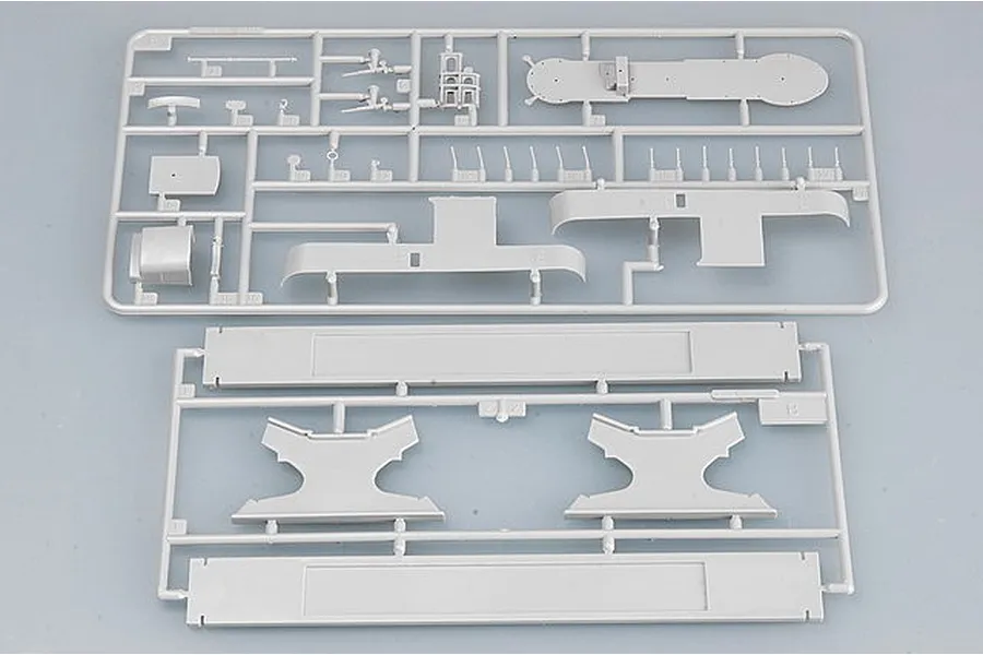 Two grey plastic model kit sprues containing submarine parts and display stand components.