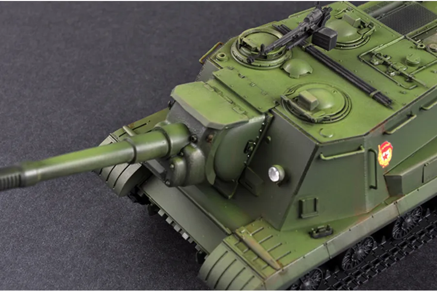 A high-angle close-up of a painted 1/35 scale model of a Soviet JSU-152K self-propelled gun, showing the olive green hull, main cannon, and turret details.