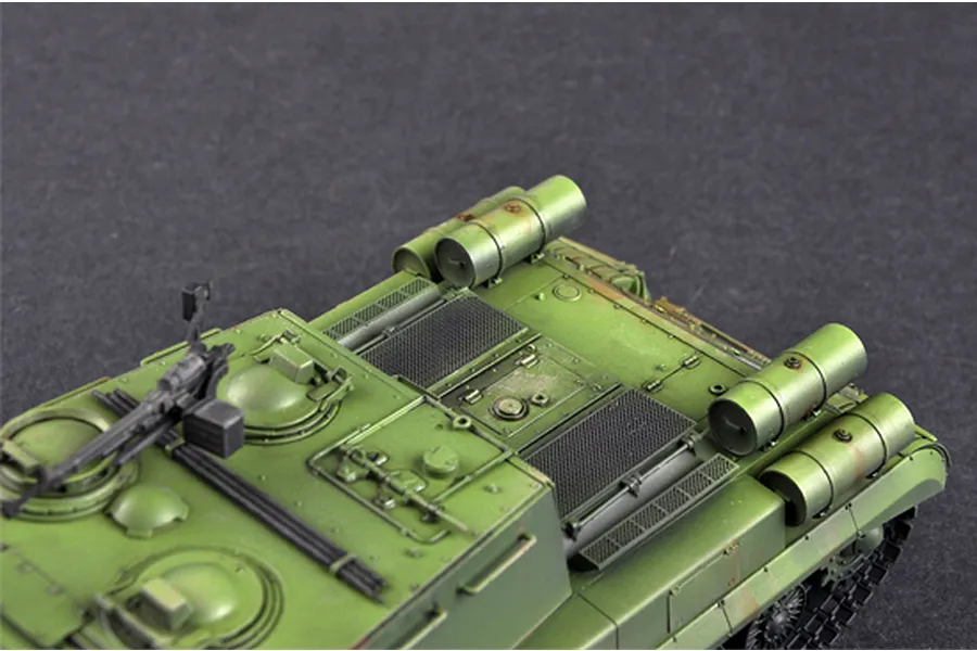 Close-up view of the rear deck of a painted 1/35 scale JSU-152K model tank, showing green camouflage, fuel drums, and a mounted machine gun.