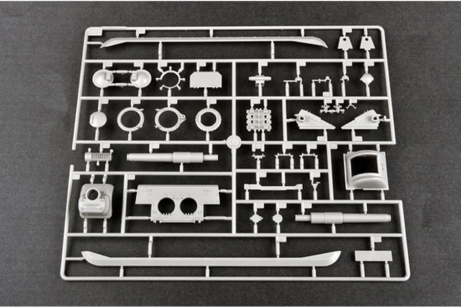 A grey plastic sprue containing various parts for a 1/35 scale model tank kit, laid out on a dark grey surface.