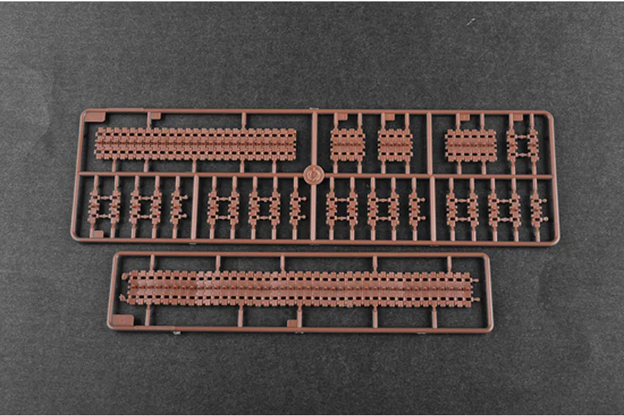 Two brown plastic sprues containing individual tank track links for a 1/35 scale model kit.