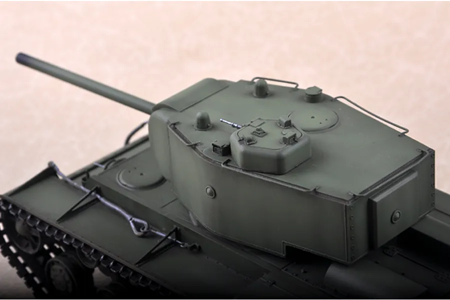 A high-angle close-up of a 1/35 scale Russian KV-220 tank model, showing the turret, main gun, and upper hull details in olive green.
