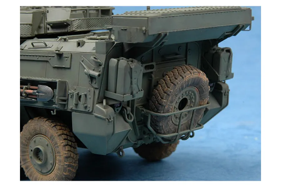 Close-up of the rear section of a 1/35 scale plastic model LAV-III armoured vehicle, showing the spare tire, jerry cans, and shovel.