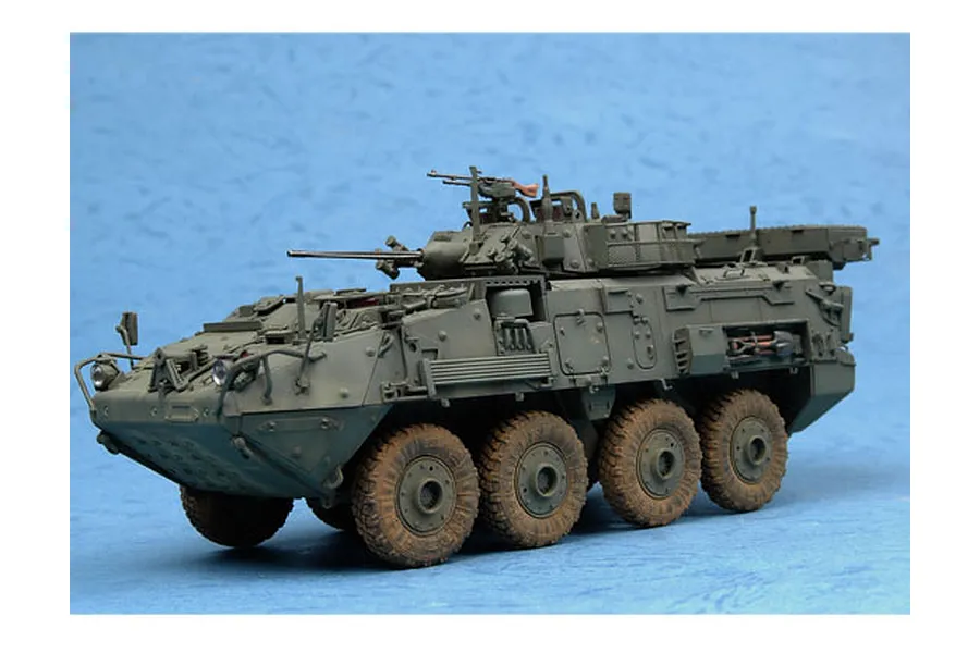 A 1/35 scale model of a LAV-III armoured vehicle, painted in olive drab with weathered tires, displayed against a blue background.